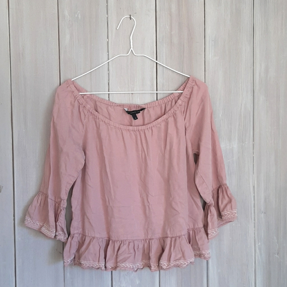 Lavender ruffle off-the-shoulder blouse.